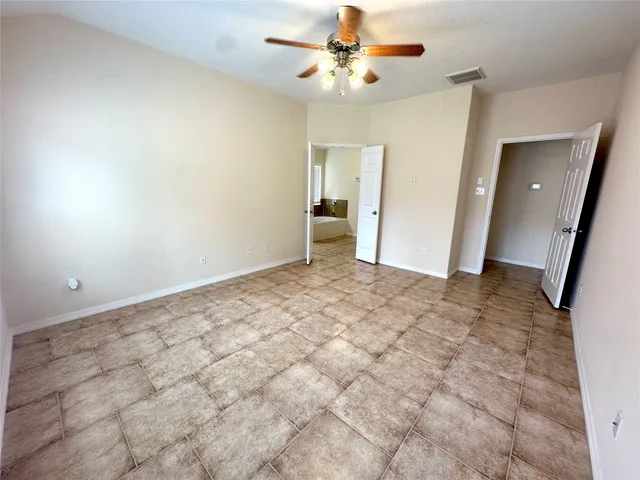 a spacious bathroom with a double vanity sink and a mirror