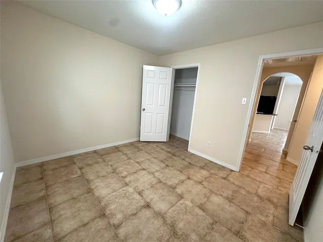 a view of a room with a exposed radiator down to a window