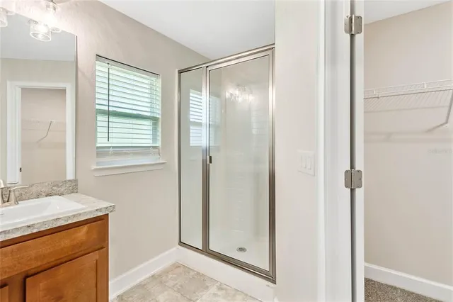 a bathroom with a shower sink and mirror