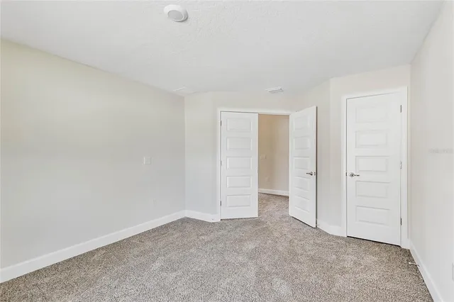 a view of an empty room and closet area