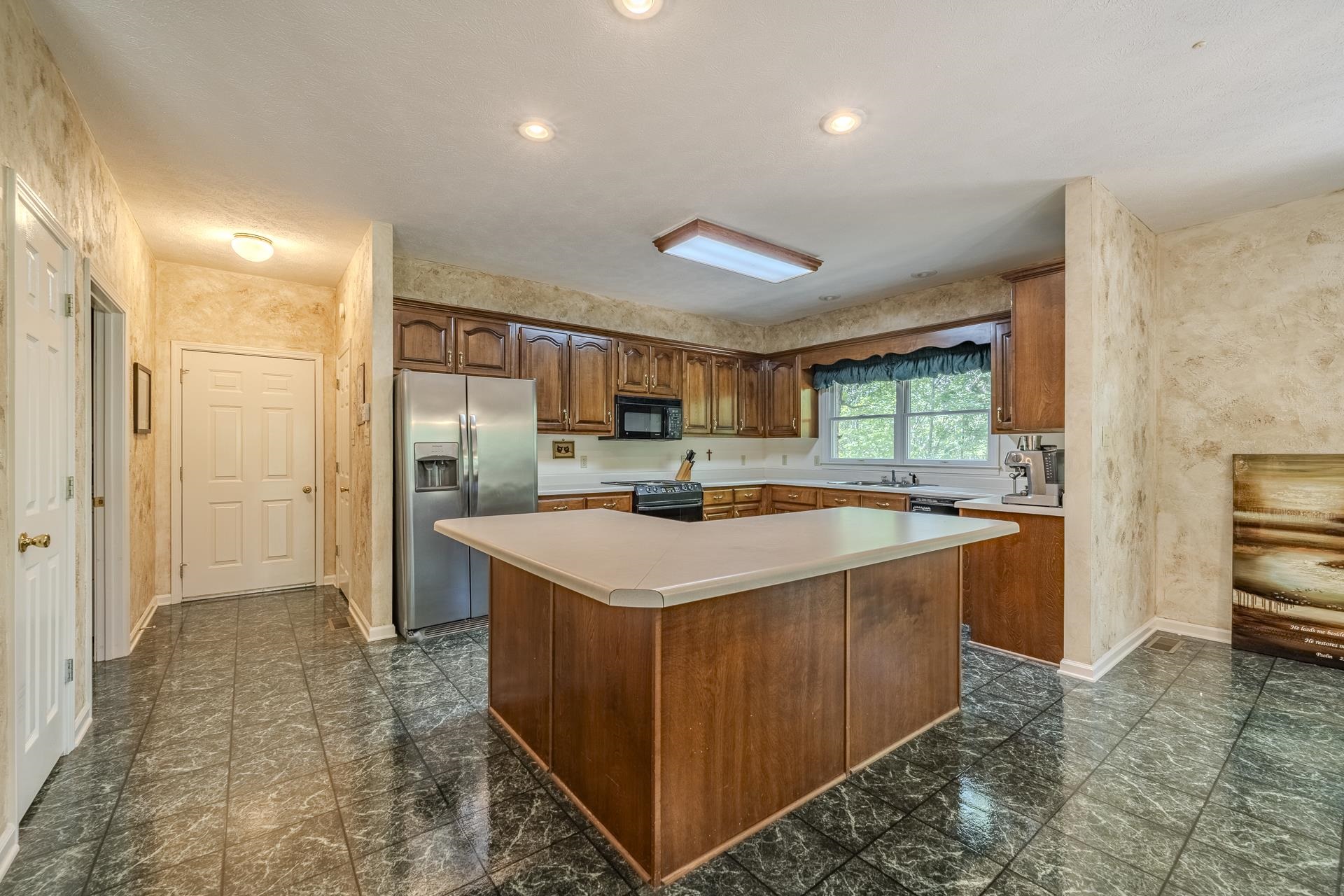 535 Old South Road Counce, TN 38326 - Photo 3 of 39 a kitchen with stainless steel appliances granite countertop a sink and a refrigerator