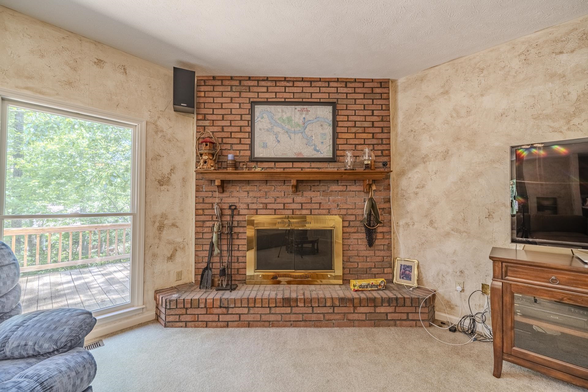 535 Old South Road Counce, TN 38326 - Photo 10 of 39 a living room with furniture a flat screen tv and a fireplace