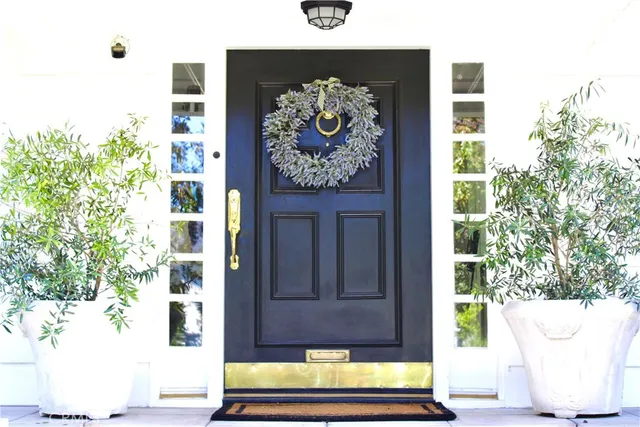 a front view of a house with yard and green space
