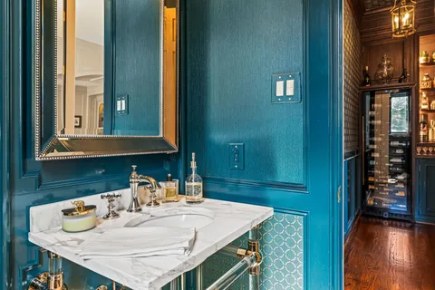 a kitchen with a stove a refrigerator and white cabinets