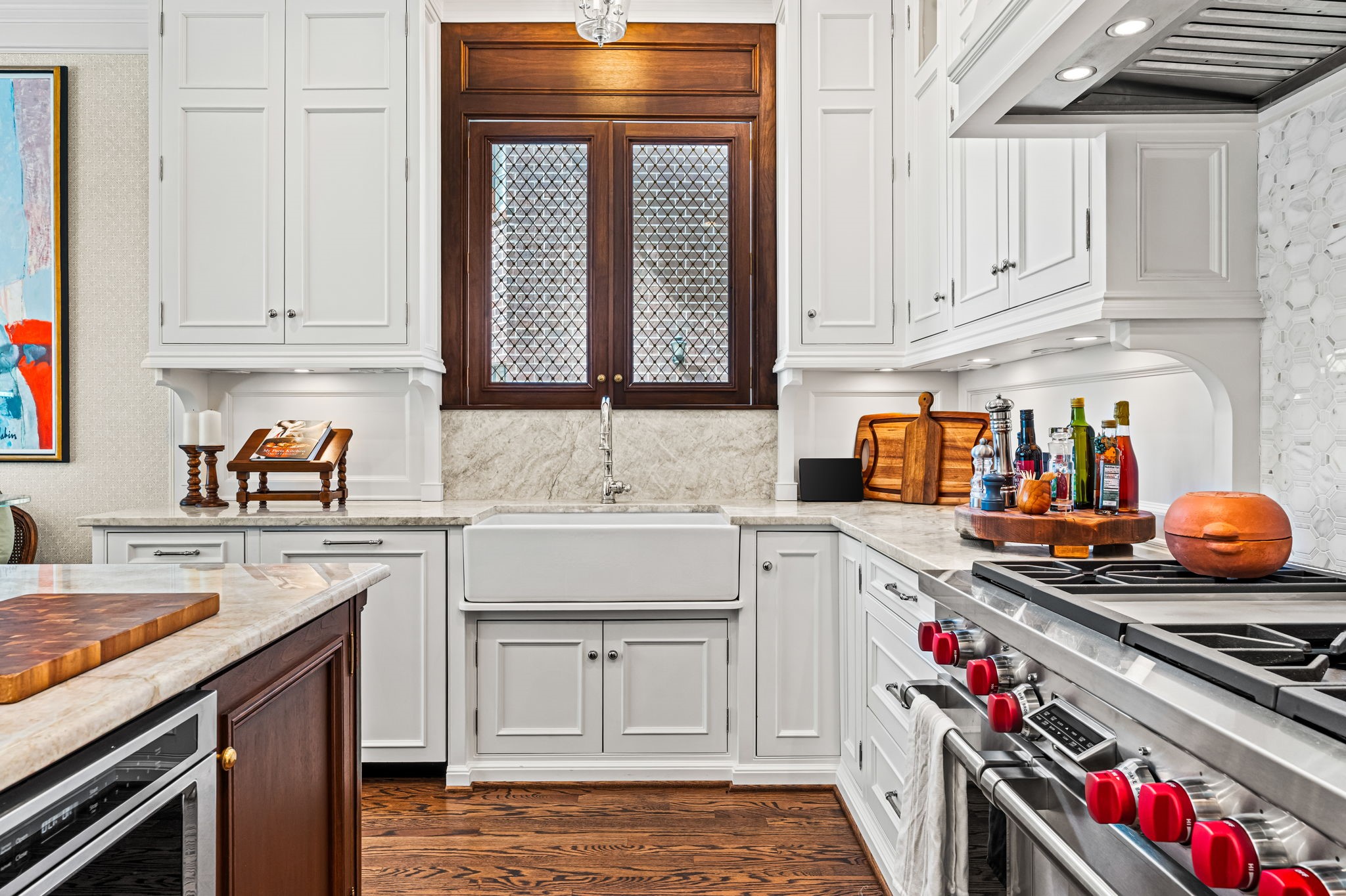 2017 Dryden Road Houston, TX 77030 - Photo 16 of 40 Wrapped in crips white custom cabinetry that stretches confidently to the ceiling, the space feels tailored from every angle. Clean-lined aneling gives it structure, wile the soft sheen of marble countertops keeps things feeling light and bright.