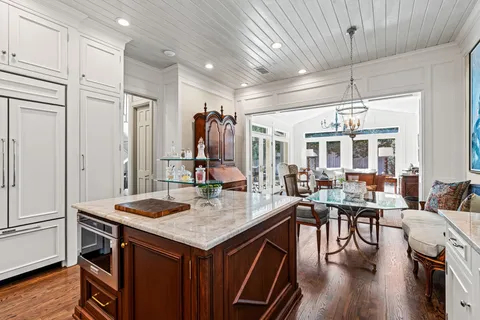 a living room with stainless steel appliances kitchen island granite countertop furniture and a kitchen view