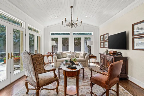 a bedroom with two beds and a chandelier