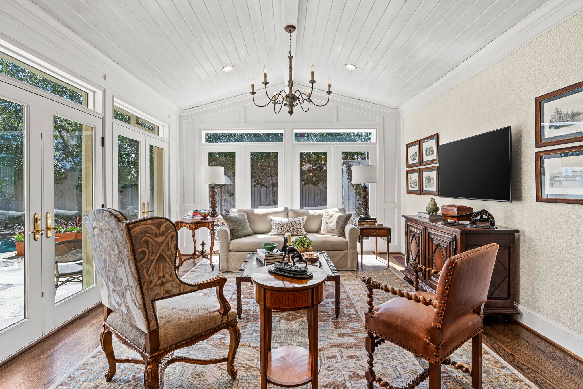 2017 Dryden Road Houston, TX 77030 - Photo 23 of 40 Originally added by the current owner, this family room - part sun room, part sanctuary - feels less like an addition and more like a revelation. The ceiling soars overhead in a graceful vault lined in crisp paneling and the walls of glass invite the outdoors in with zero hesitation. Even on a cloudy day, the room feels bright and buoyant.