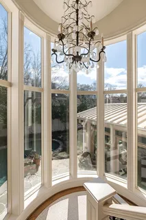 a bedroom with a bed a bookshelf and a flat screen television