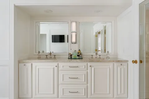a bathroom with a granite countertop sink a toilet and a mirror