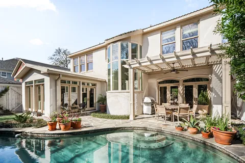 a view of a house with swimming pool and sitting area
