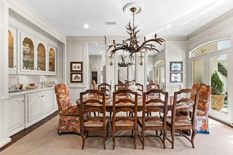 a view of a dining room with furniture and a chandelier