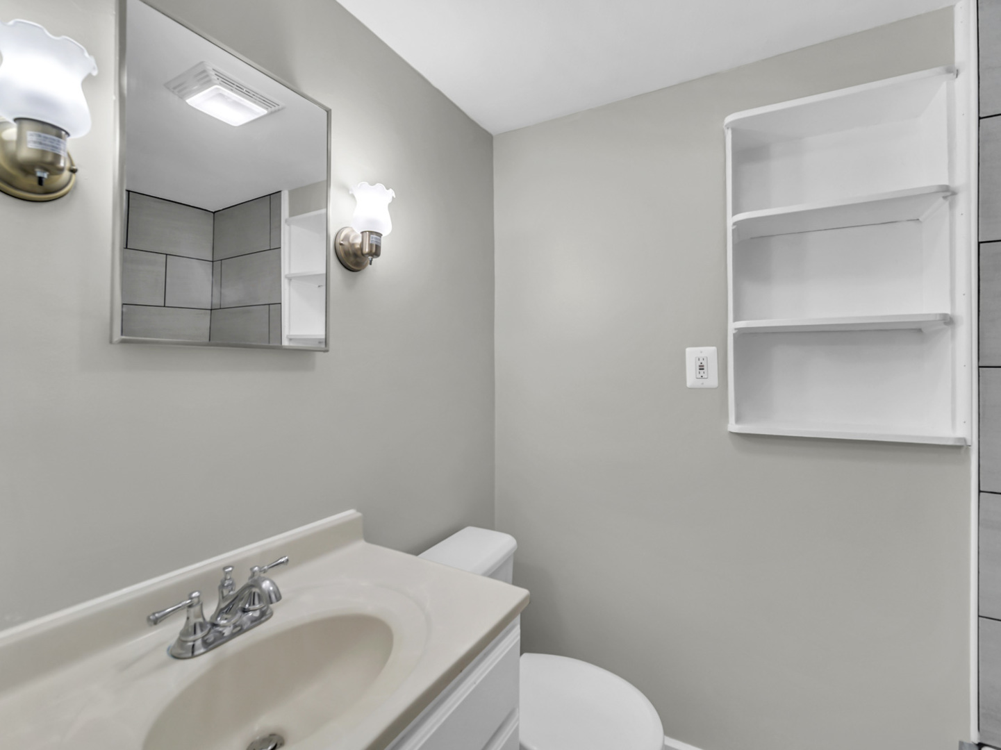 1820 Tomahawk Trail Round Lake Heights, IL 60073 - Photo 12 of 23 a bathroom with a sink a toilet and a mirror