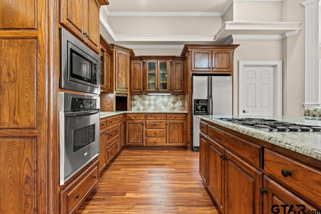 100 Lantana Road Gilmer, TX 75644 - Photo 7 of 30 a kitchen with stainless steel appliances granite countertop a stove and a refrigerator