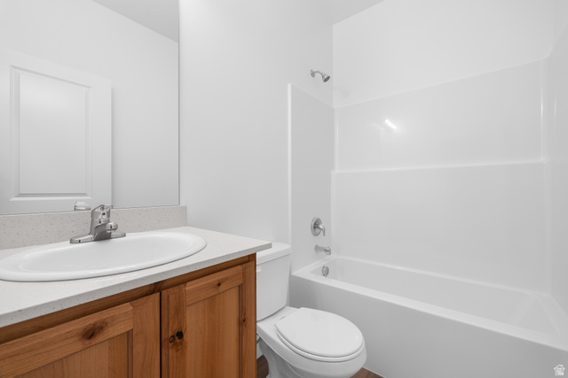 1563 South Deerbrook Road, Unit 267CHM Santaquin, UT 84655 - Photo 11 of 13 Full bathroom featuring a wood-finish vanity with a light-toned countertop, an integrated sink, and a chrome faucet