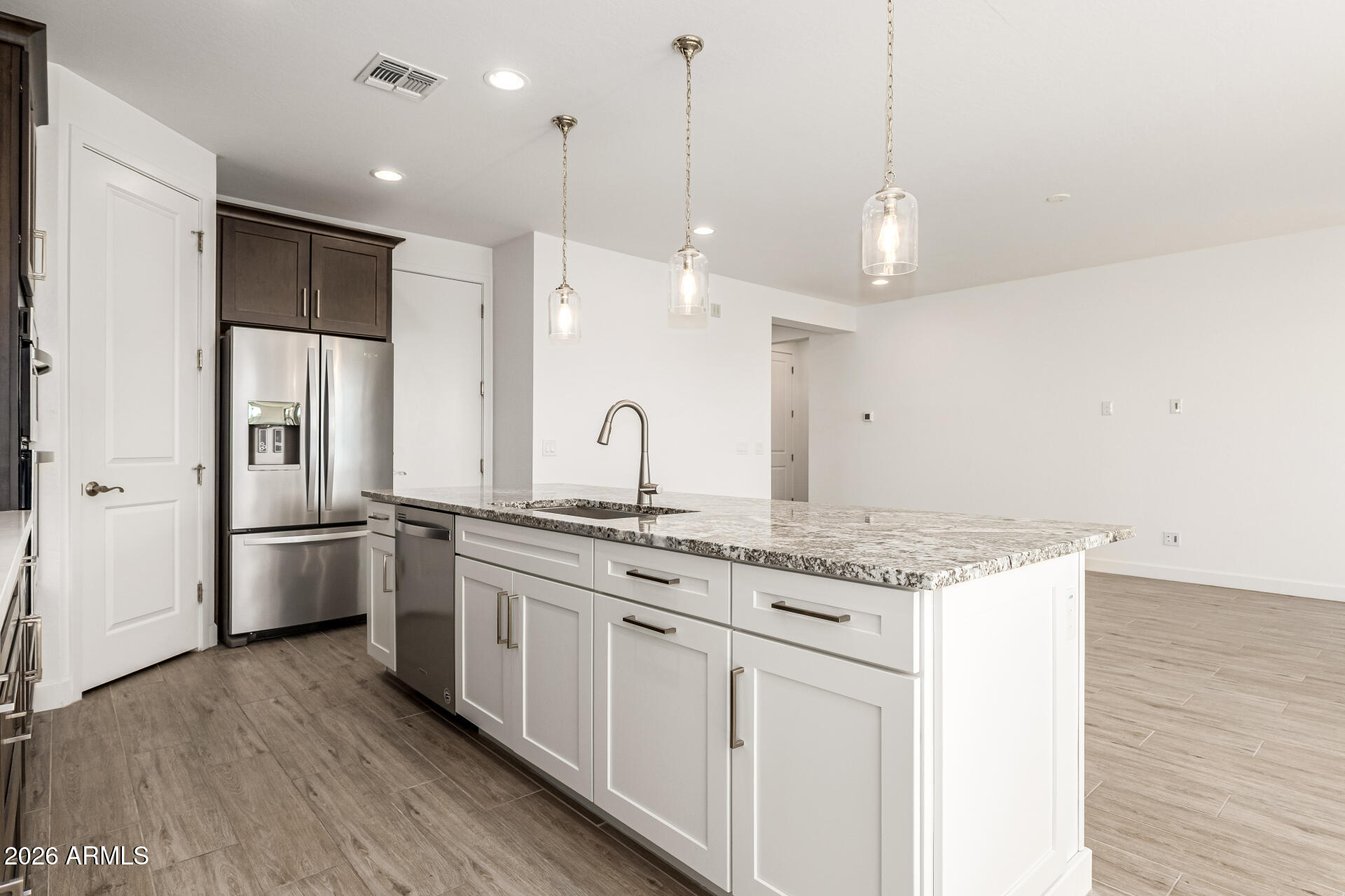 735 East Marblewood Way Phoenix, AZ 85048 - Photo 15 of 35 a kitchen with stainless steel appliances granite countertop a sink a stove a refrigerator and island with wooden floor