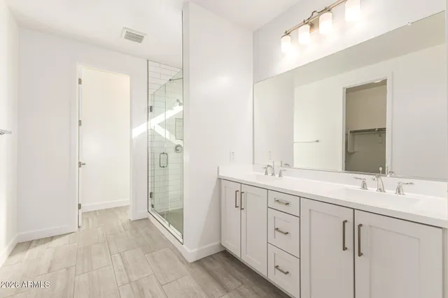 a spacious bathroom with a double vanity sink mirror and double