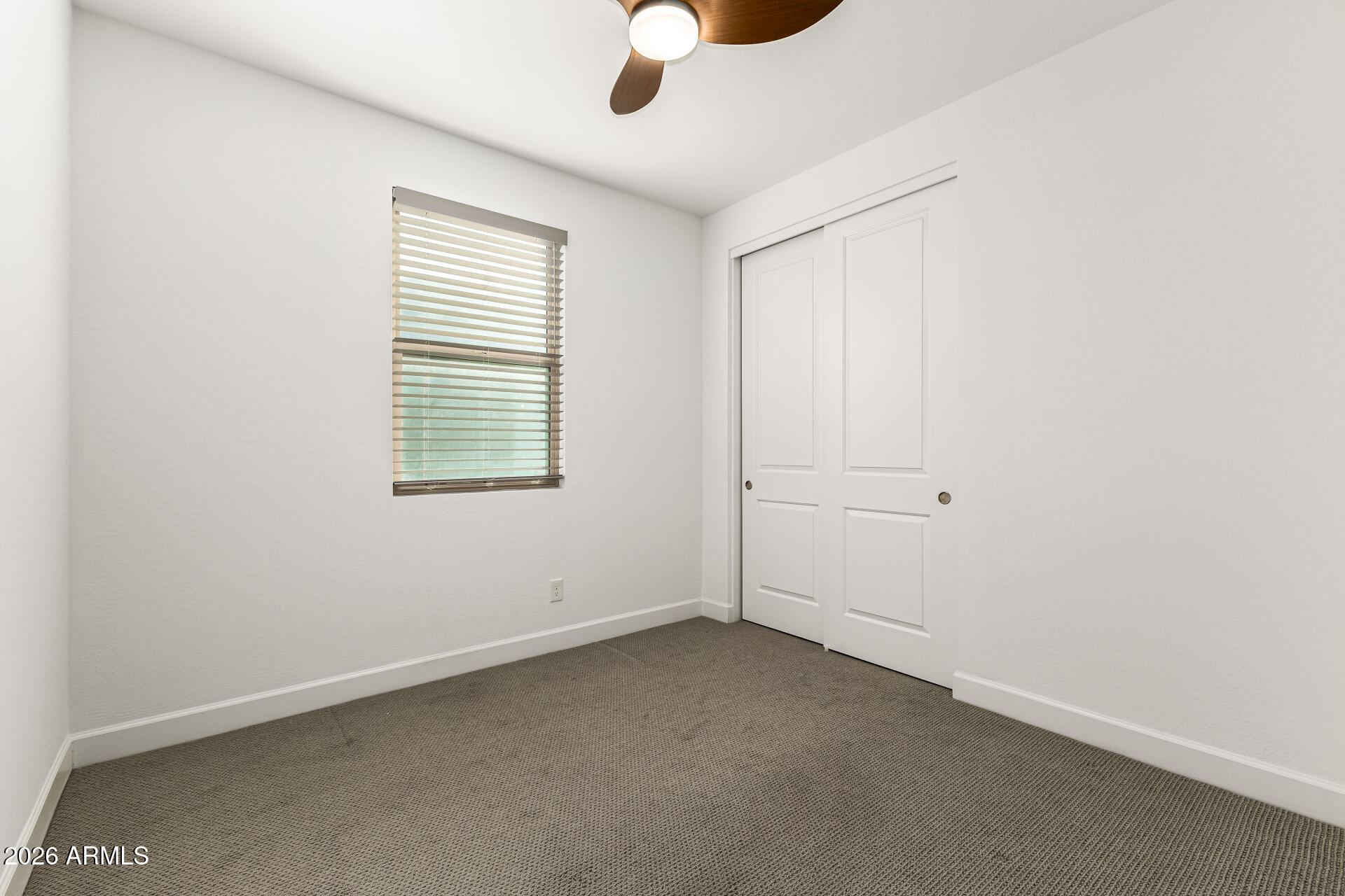735 East Marblewood Way Phoenix, AZ 85048 - Photo 23 of 35 an empty room with ceiling fan and windows