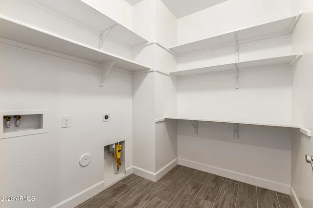a view of walk in closet with empty racks