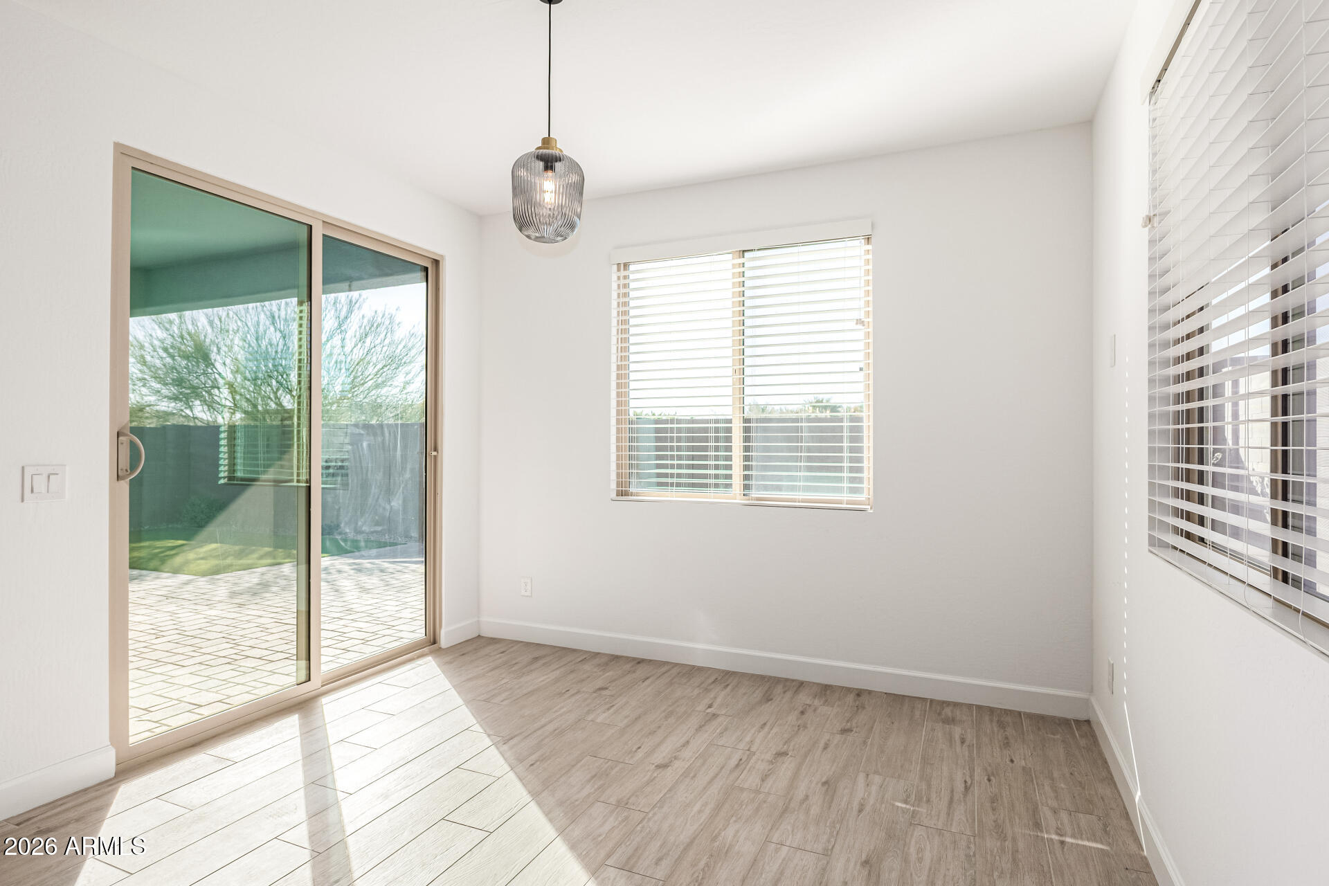 735 East Marblewood Way Phoenix, AZ 85048 - Photo 8 of 35 a view of an empty room with wooden floor and a window