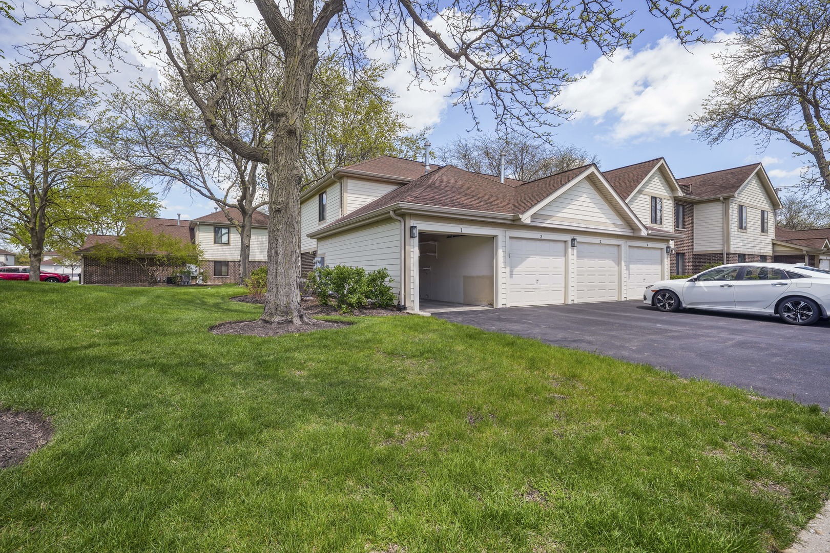 924 Coach Road, Unit 1 Palatine, IL 60074 - Photo 21 of 23 a front view of a house with a garden and trees