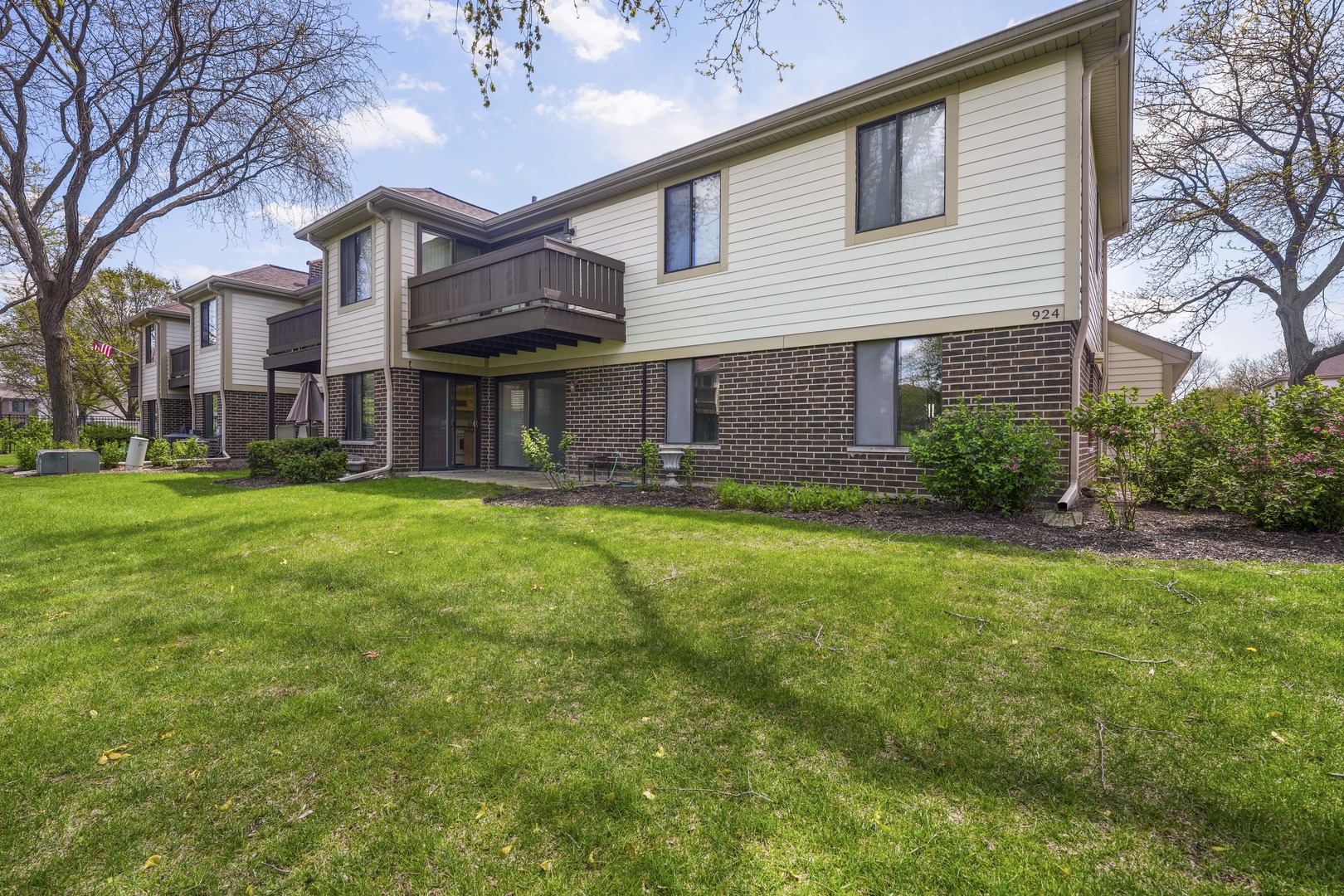 924 Coach Road, Unit 1 Palatine, IL 60074 - Photo 23 of 23 a front view of a house with a yard