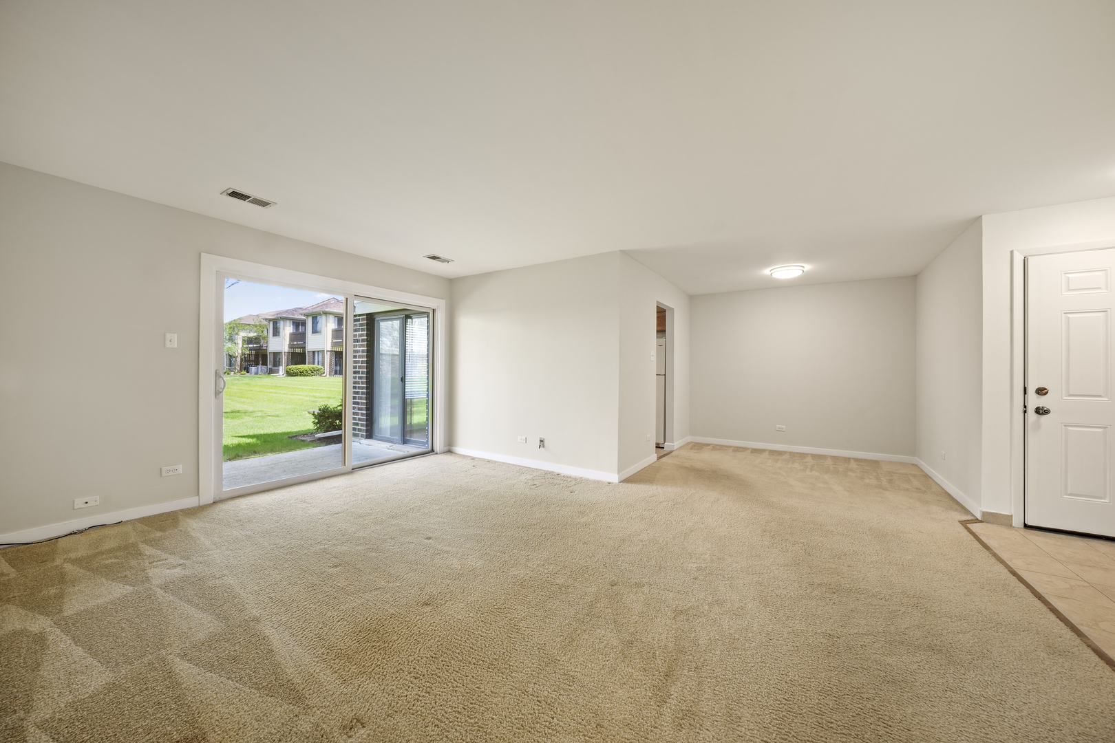 924 Coach Road, Unit 1 Palatine, IL 60074 - Photo 3 of 23 a view of an empty room with a window