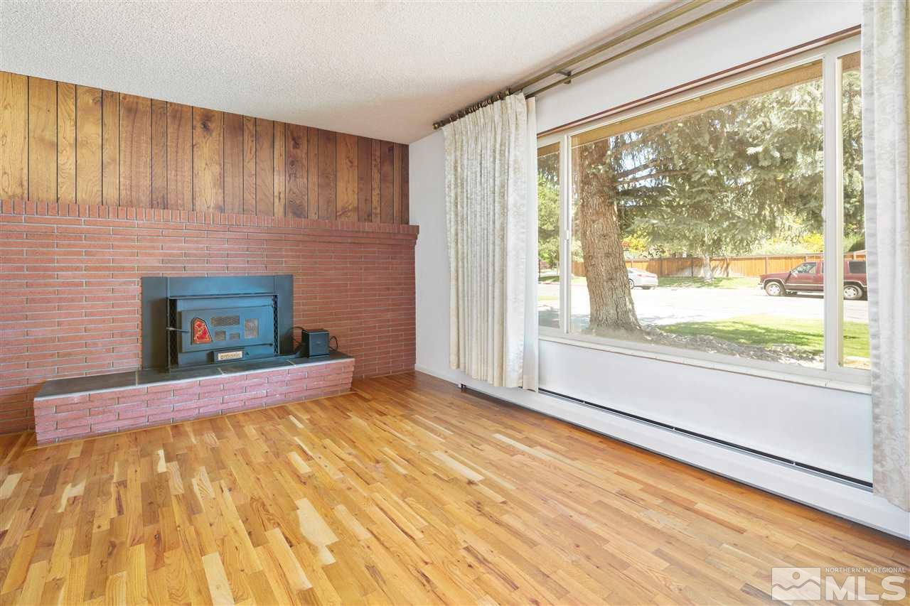 1830 Allen Street, Unit NV Reno, NV 89509 - Photo 3 of 24 a view of empty room with wooden floor and fireplace