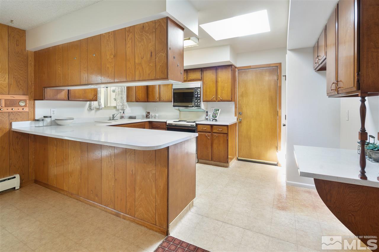 1830 Allen Street, Unit NV Reno, NV 89509 - Photo 8 of 24 a kitchen with stainless steel appliances granite countertop a sink a stove and a refrigerator