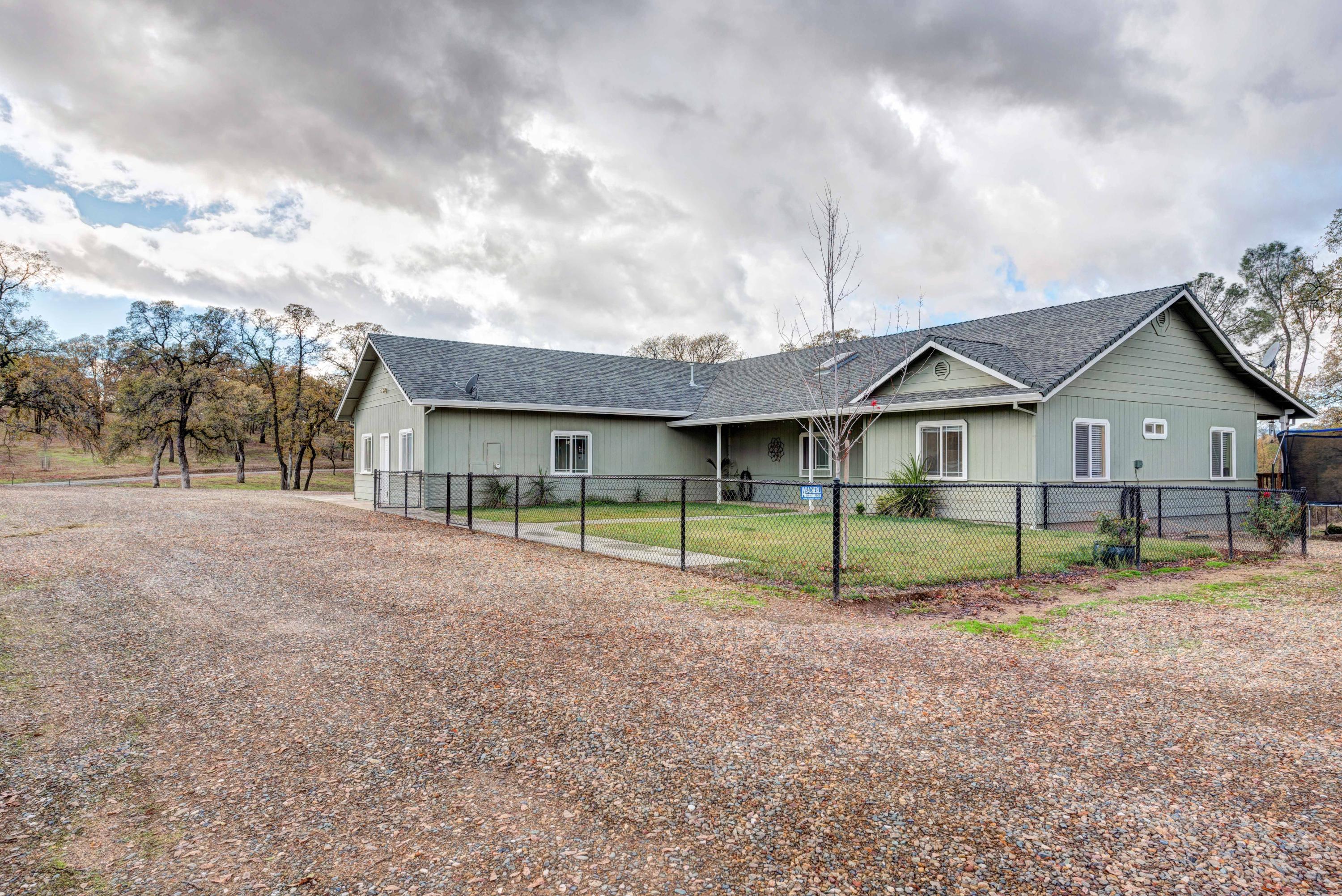 a view of house with a backyard