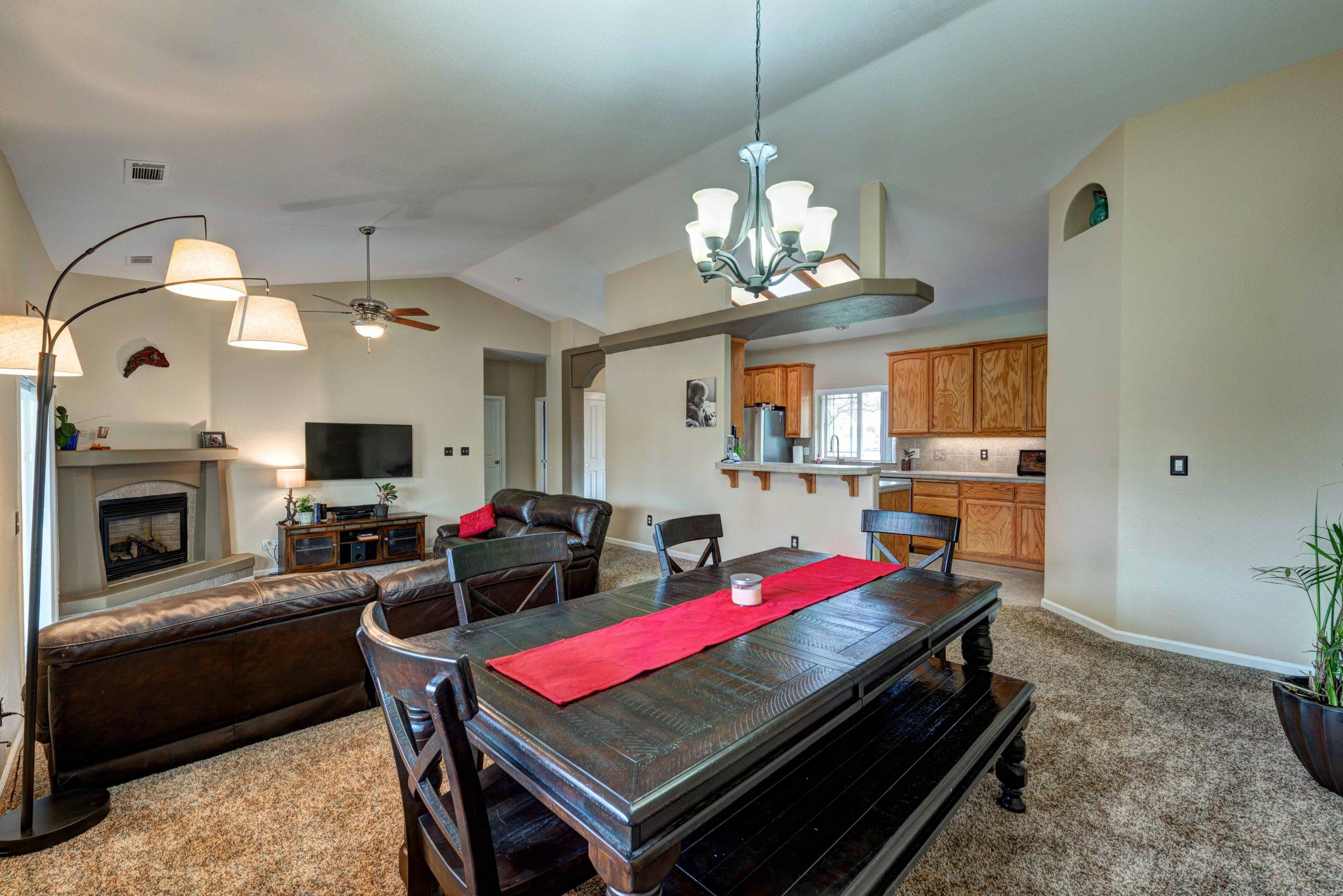 13711 Gas Point Road Igo, CA 96047 - Photo 11 of 29 a living room with dining table furniture a fireplace and kitchen view