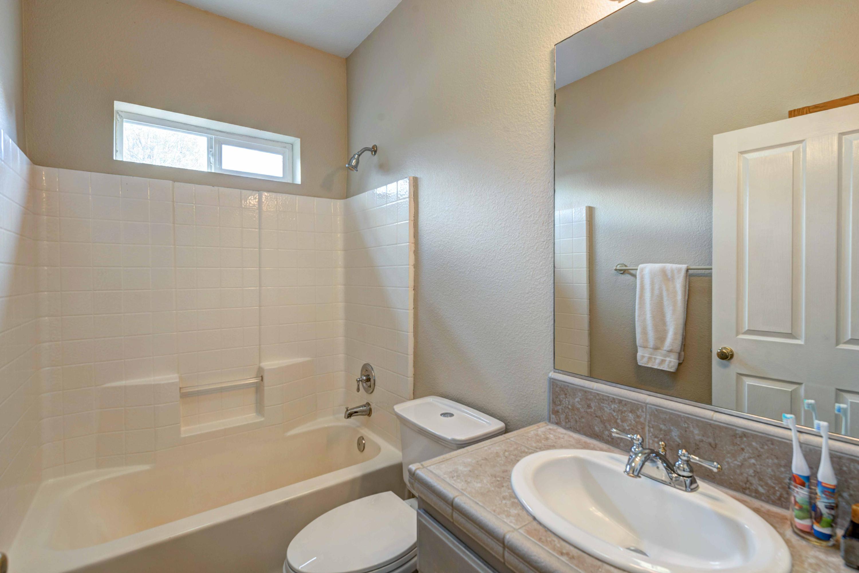13711 Gas Point Road Igo, CA 96047 - Photo 16 of 29 a bathroom with a granite countertop sink toilet and shower