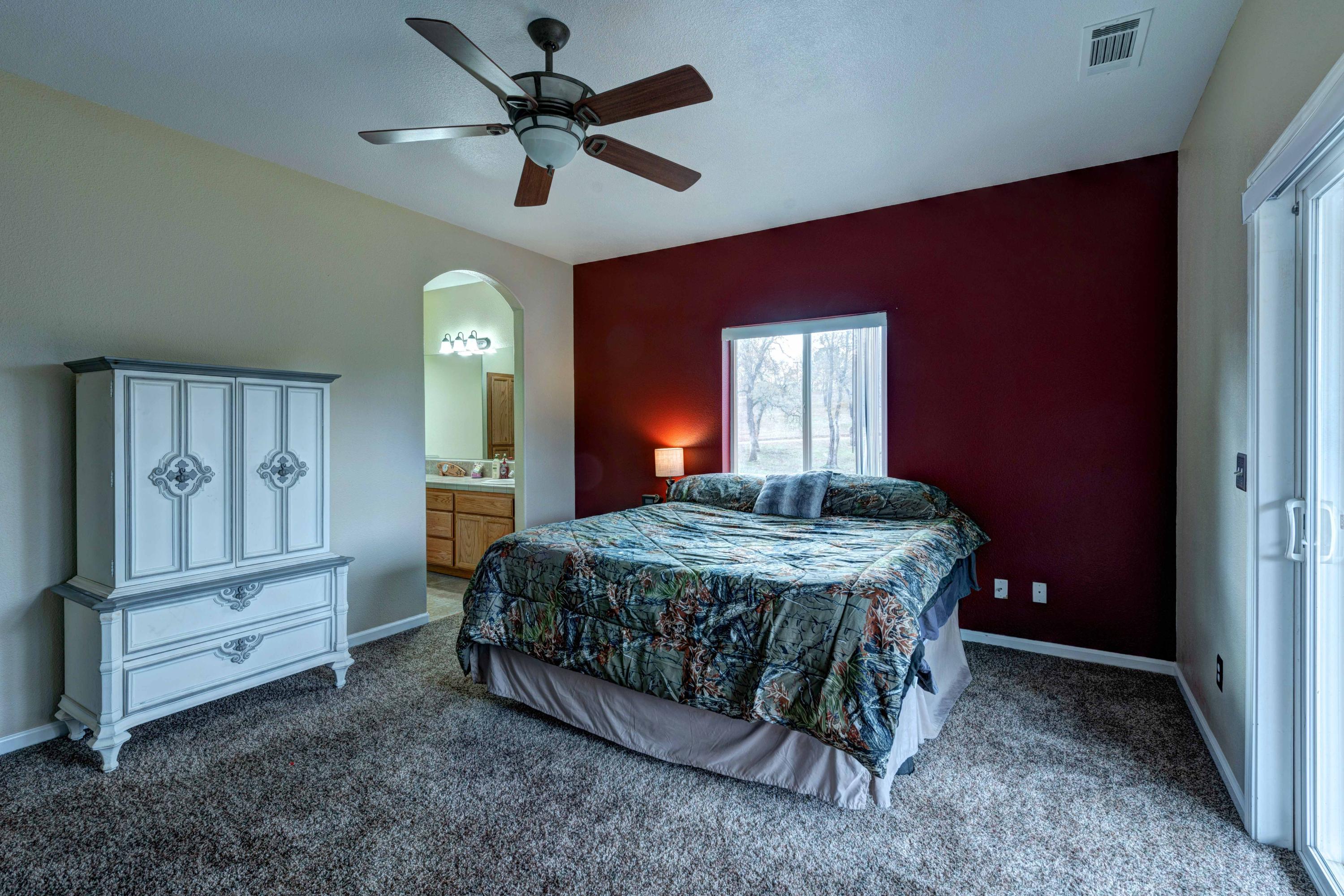 13711 Gas Point Road Igo, CA 96047 - Photo 17 of 29 a spacious bedroom with a bed table and closet