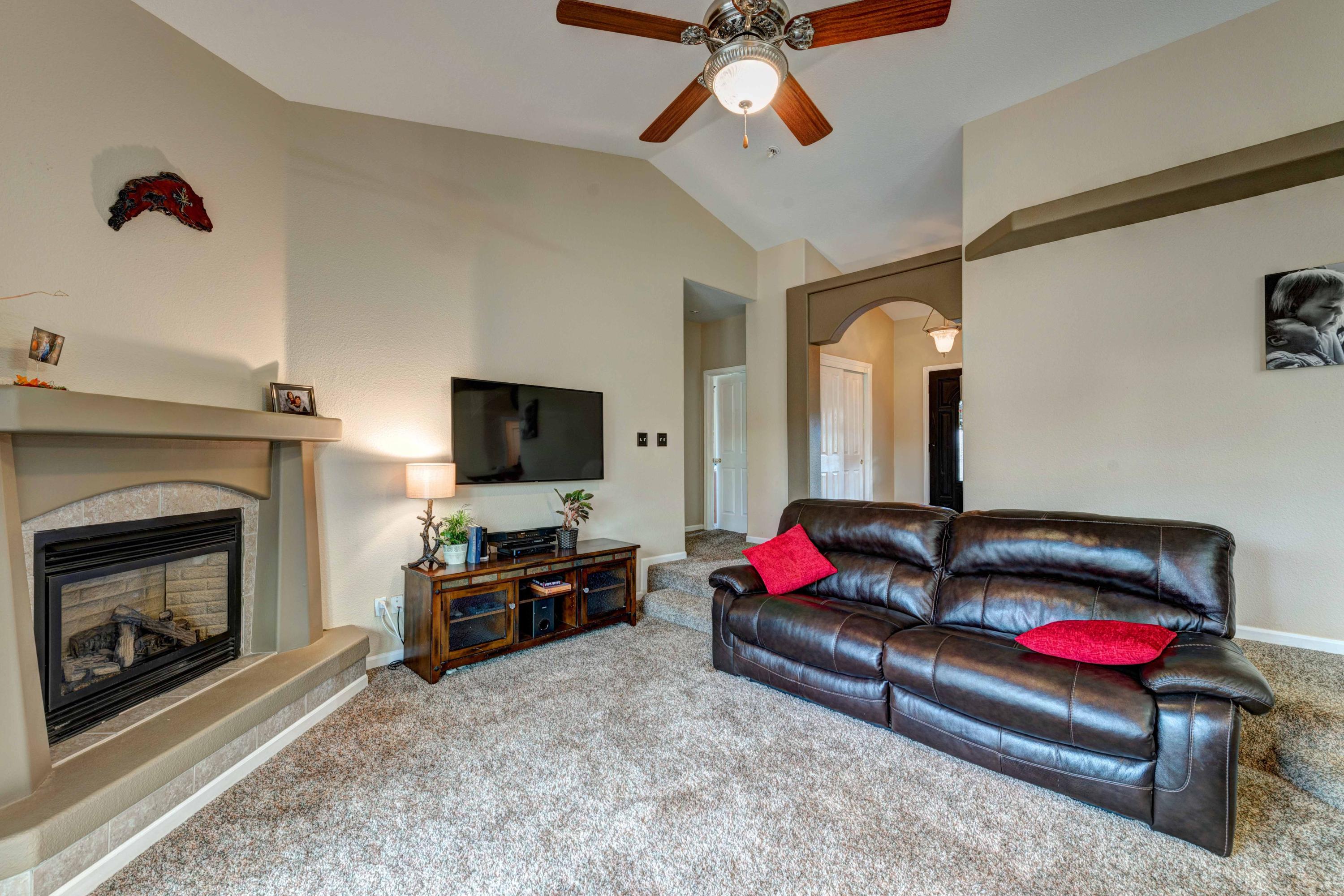 13711 Gas Point Road Igo, CA 96047 - Photo 6 of 29 a living room with furniture a flat screen tv and a fireplace