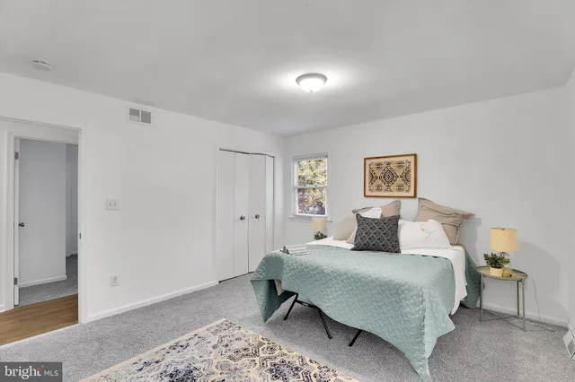 a bedroom with a bed and a lamp with window