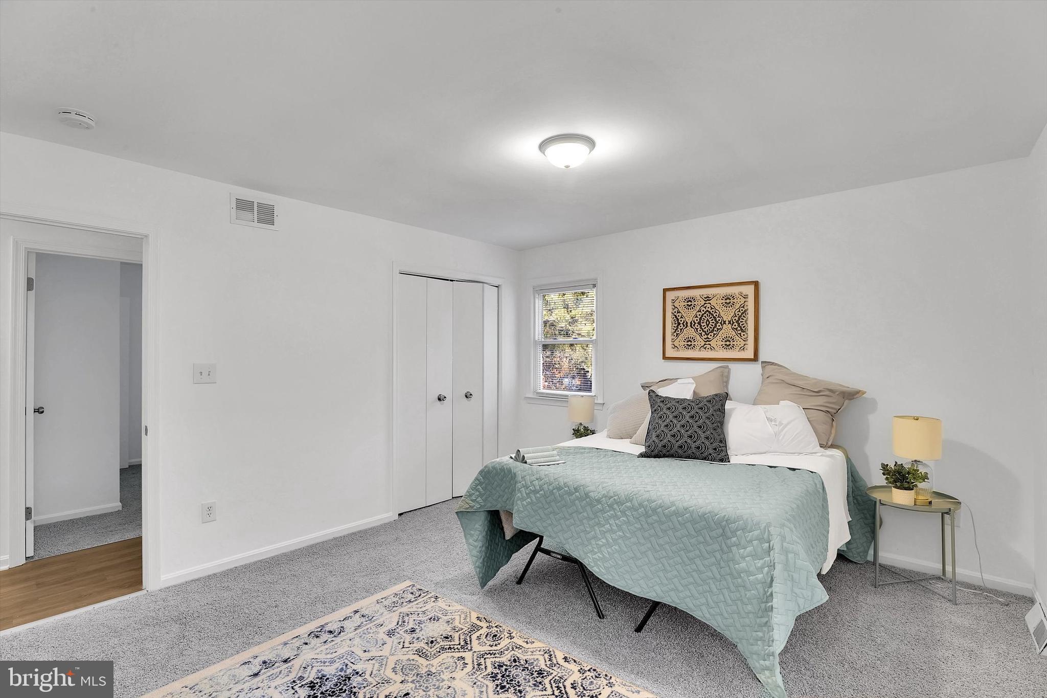 560 Edwards Drive Odenton, MD 21113 - Photo 18 of 39 a bedroom with a bed and a lamp with window