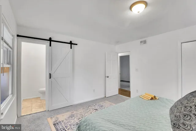 a bedroom with a bed and a shower