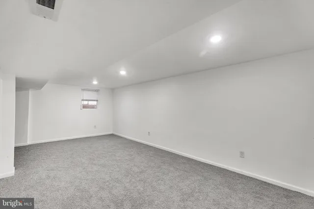 an empty room with a empty space and windows