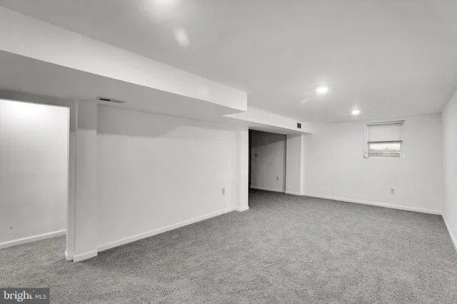 an empty room with a empty space and windows