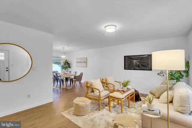 a living room with furniture a mirror and a lamp