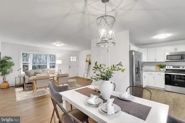 a view of a dining room with furniture a livingroom and chandelier