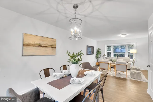 a view of a dining room with furniture wooden floor and chandelier