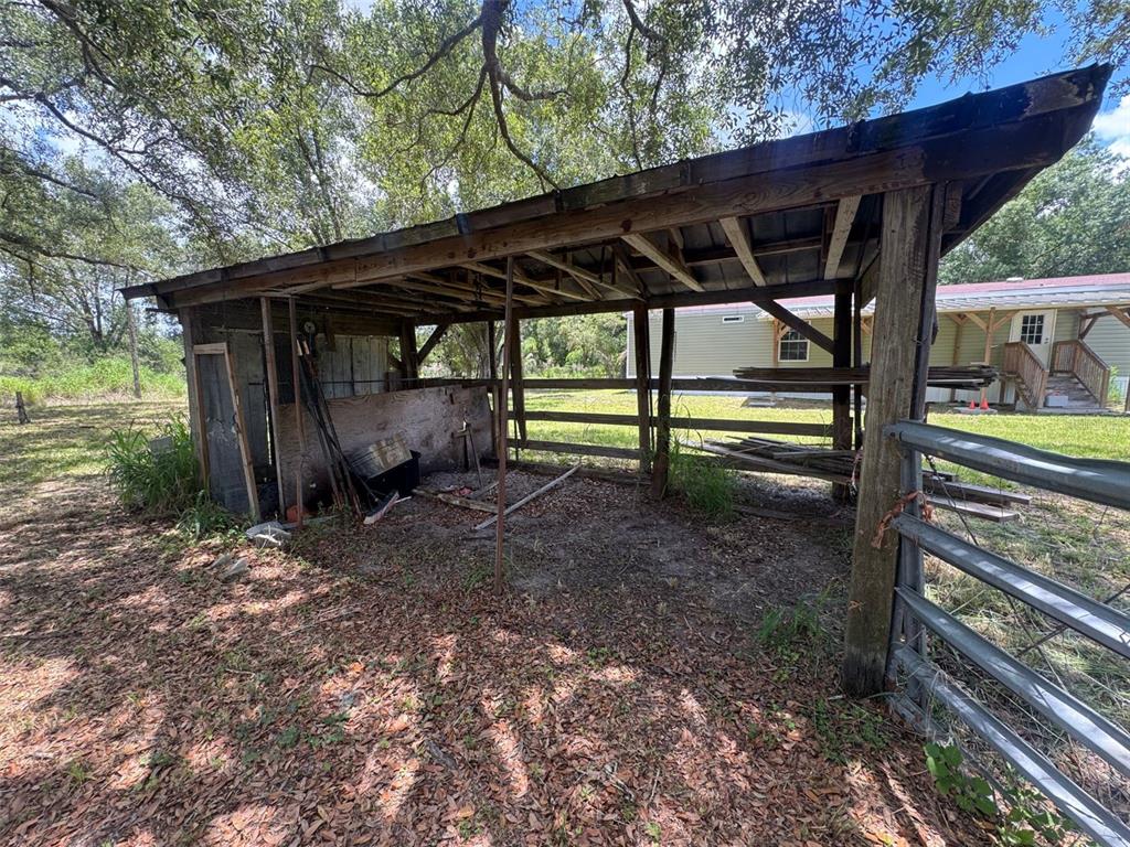 9827 Southeast Hoth Road Arcadia, FL 34266 - Photo 11 of 28 a view of backyard with green space and wooden deck