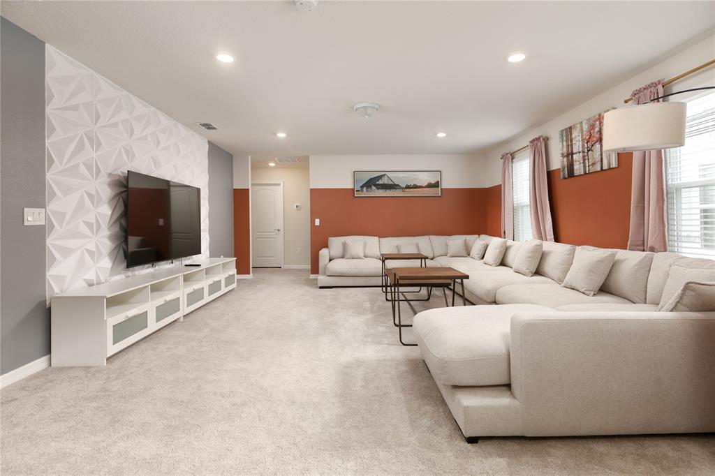 7208 Oakmoss Loop Davenport, FL 33837 - Photo 20 of 46 a living room with furniture and a flat screen tv