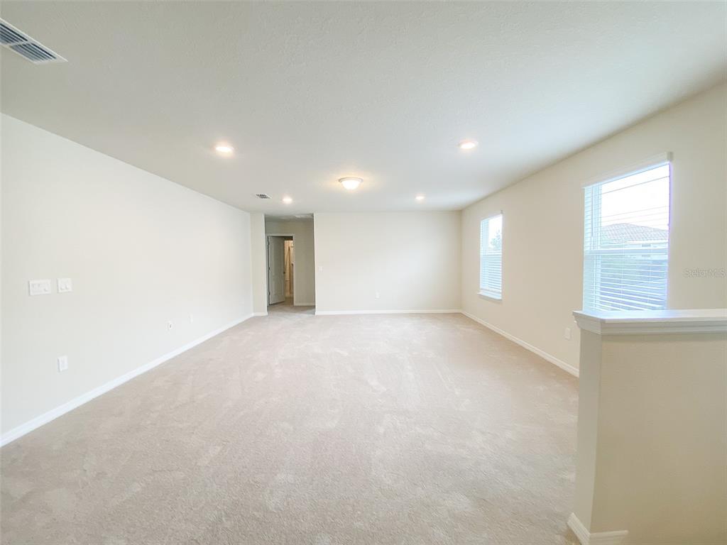 7208 Oakmoss Loop Davenport, FL 33837 - Photo 21 of 46 a view of an empty room with a window