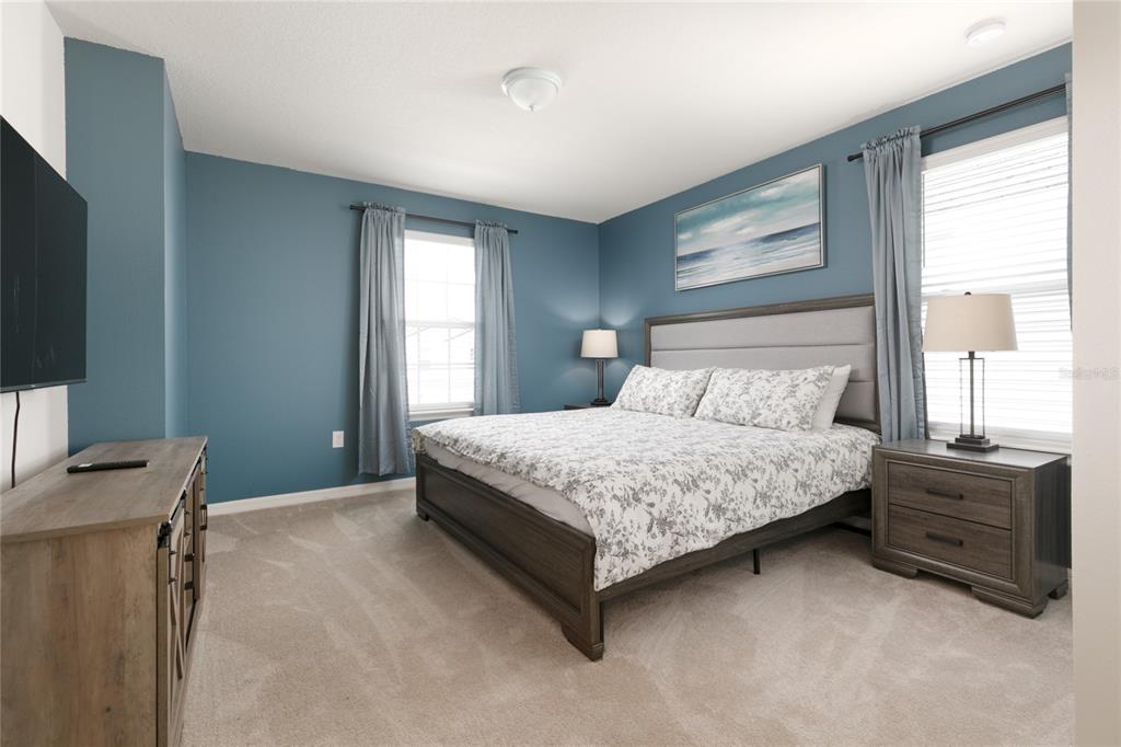 7208 Oakmoss Loop Davenport, FL 33837 - Photo 23 of 46 a bedroom with a bed and a window