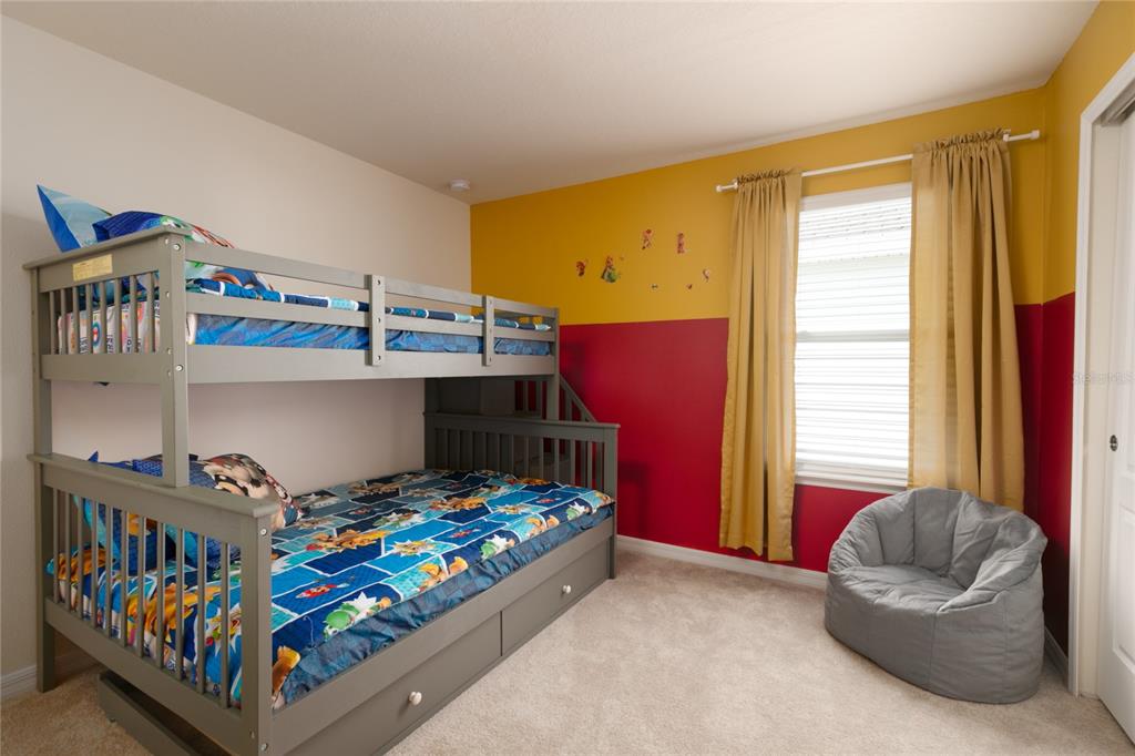 7208 Oakmoss Loop Davenport, FL 33837 - Photo 26 of 46 a bedroom with a bed and a window