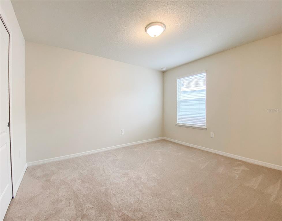 7208 Oakmoss Loop Davenport, FL 33837 - Photo 31 of 46 an empty room with windows