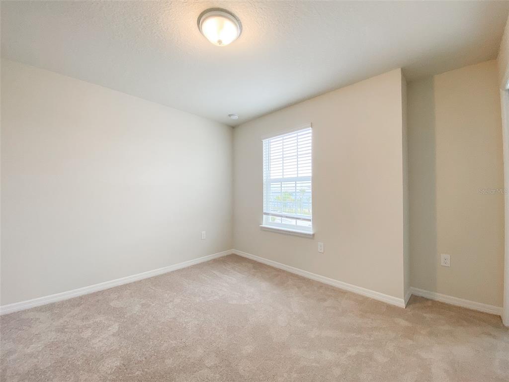 7208 Oakmoss Loop Davenport, FL 33837 - Photo 34 of 46 an empty room with a window
