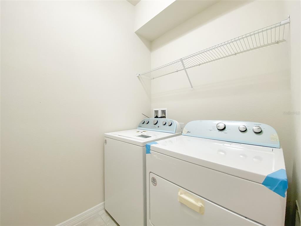 7208 Oakmoss Loop Davenport, FL 33837 - Photo 36 of 46 a utility room with dryer and washer
